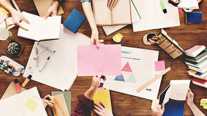 Foto eines Tisches, auf dem Bücher und Papiere liegen