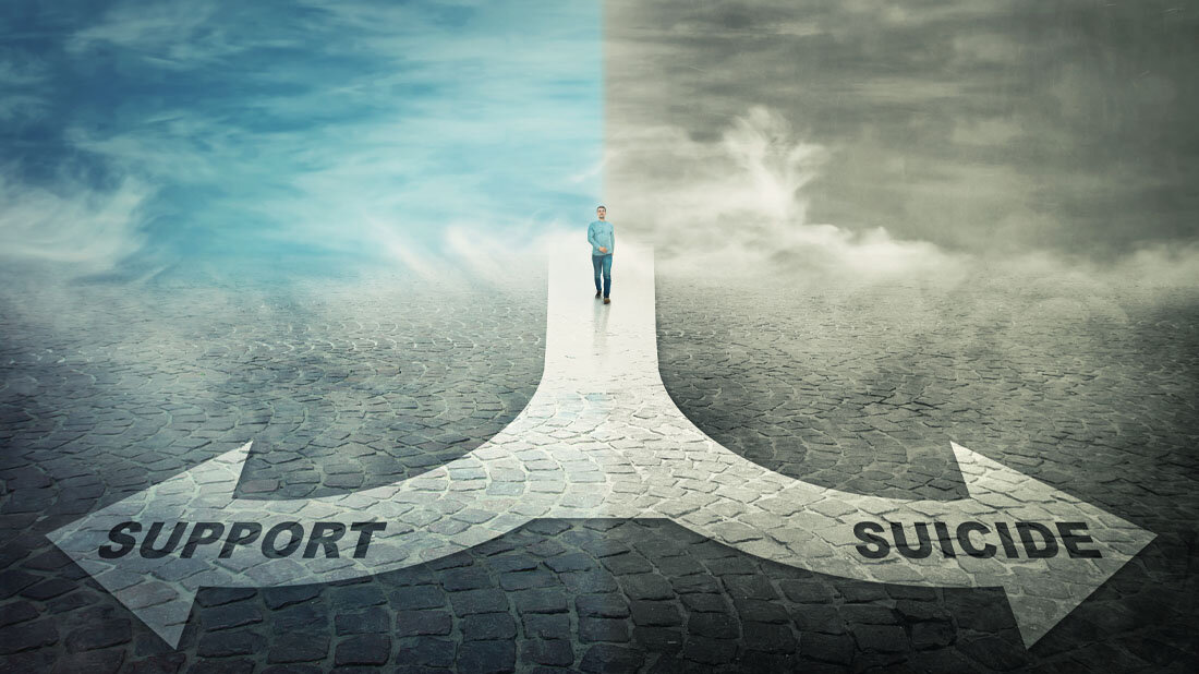 Suizidpraevention.jpg Eine Person steht am Scheideweg, entweder Richtung Suicide oder Support zu gehen.
