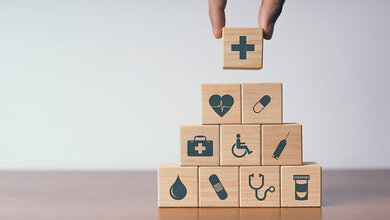 Fachberufekonferenz der Bundesärztekammer: Fokus auf Prävention und Förderung der Gesundheitskompetenz richten Foto auf dem auf einen Stapel Holzwürfel der abschließende letzte gelegt wird