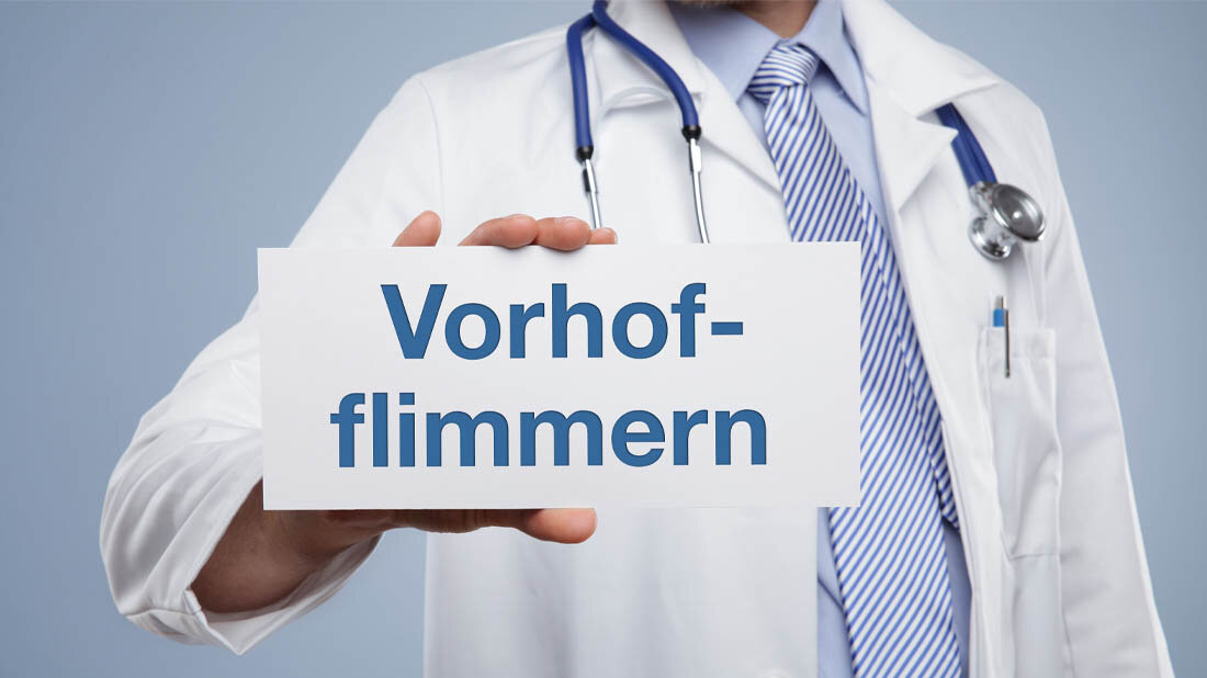 Vorhofflimmern_01.jpg Ein Arzt hält ein Schild mit dem Aufdruck Vorhofflimmern.