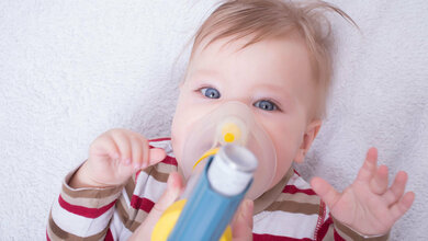 Kleines Kind mit Asthmainhalator