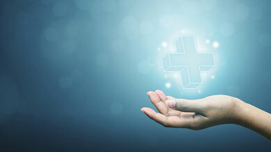 Symboldarstellung: Hand hält Krankenhaussymbol