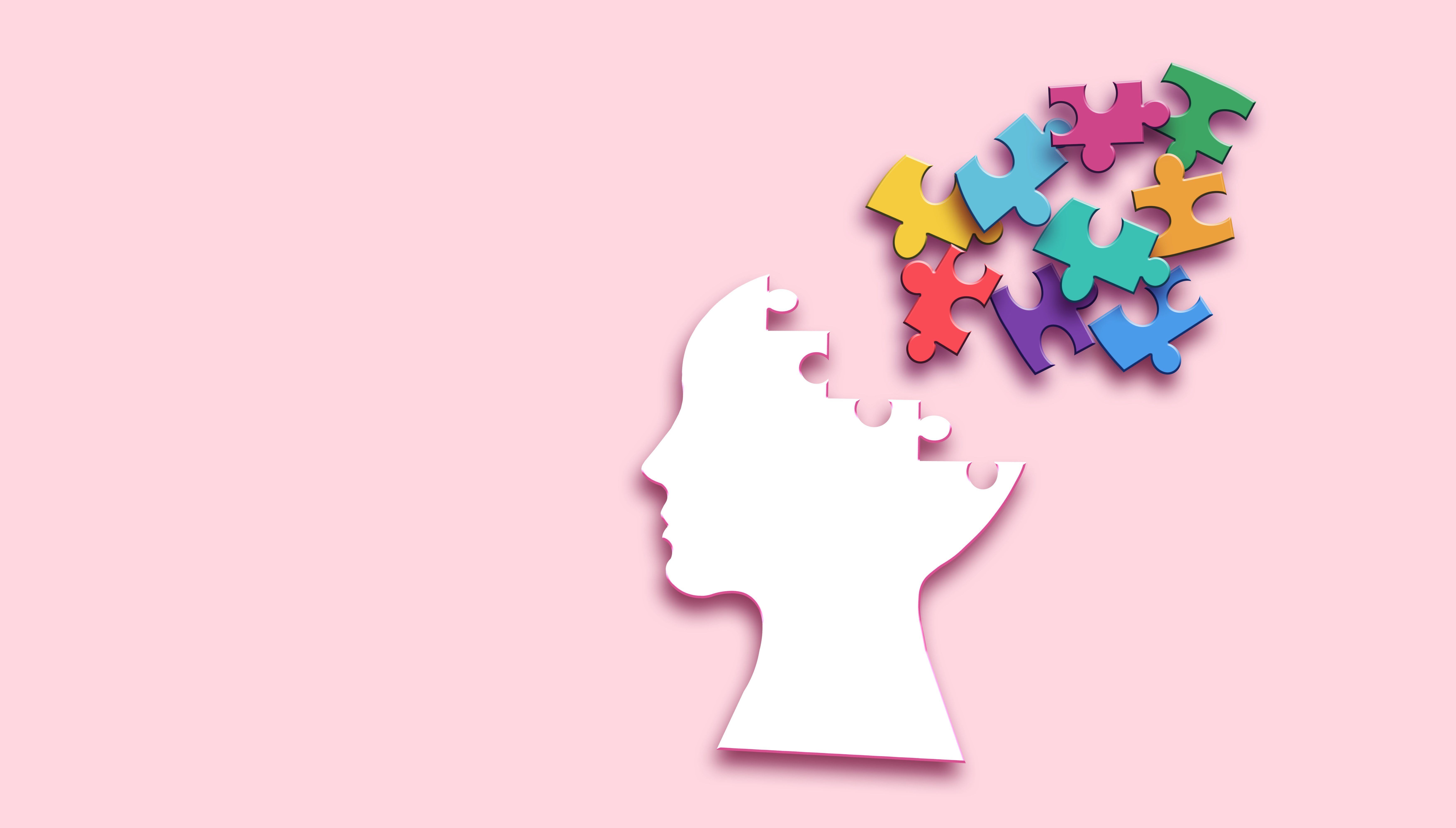 Das Bild zeigt einen menschlichen Kopf in Form eines Puzzles, aus dem bunte Puzzleteile herausfliegen. Dies symbolisiert Themen wie mentale Gesundheit, kognitive Prozesse oder Gedächtnis.